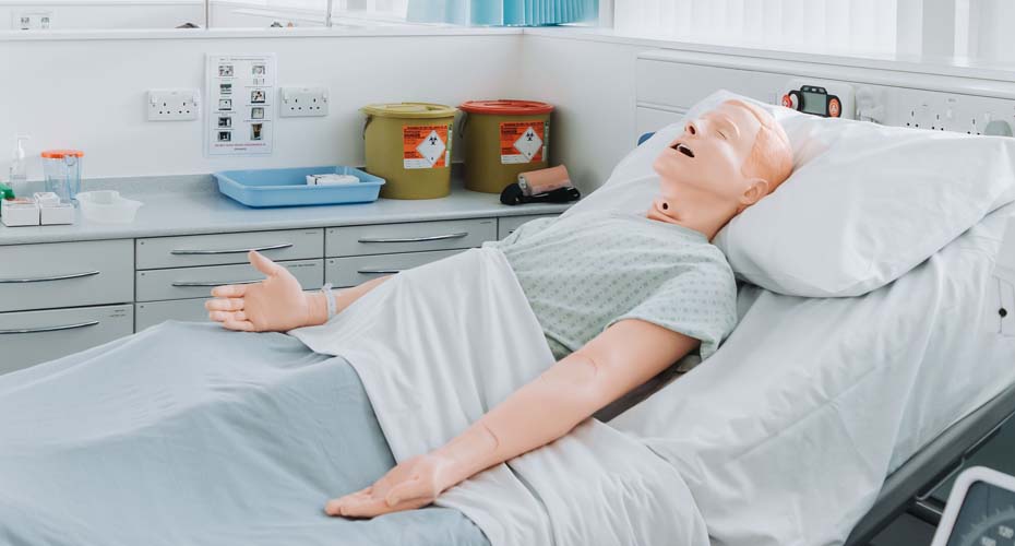 Nursing manekin in hospital bed
